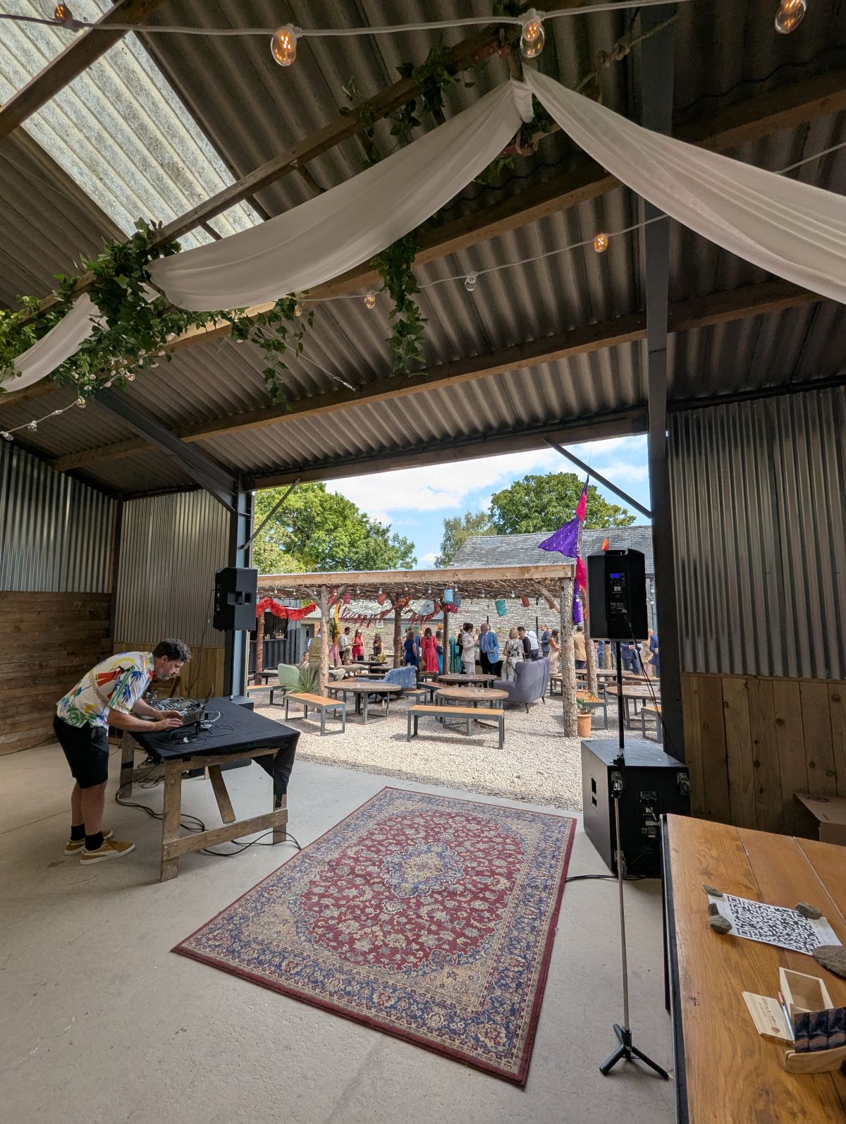 dj set up in a barn venue during drinks reception