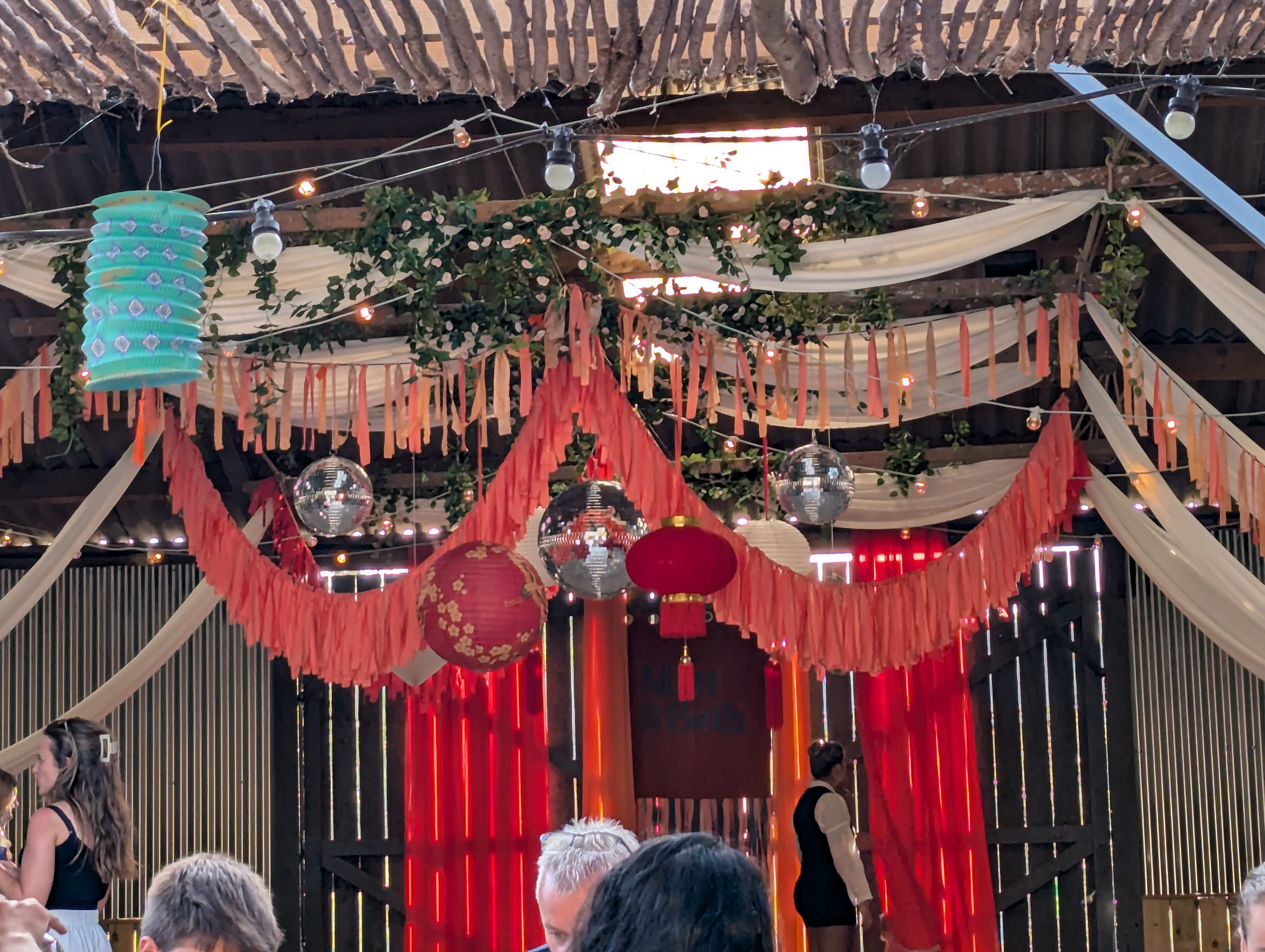 drapes hung from wedding venue barn beams