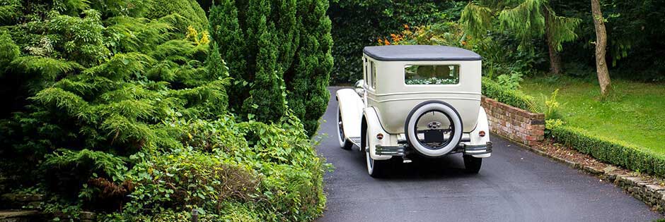 White wedding car driving away