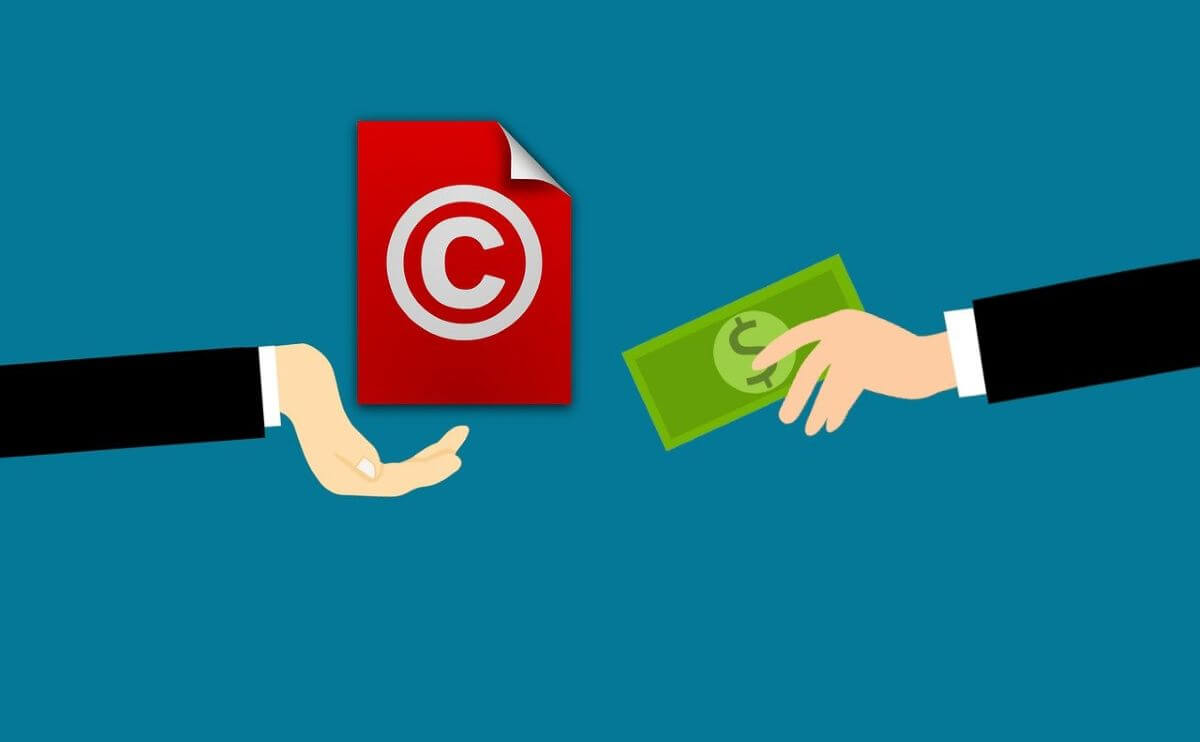 image of two hands exchanging money for copyright permissions