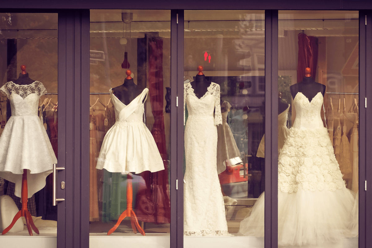 bridal shop store front with 4 dresses in the window